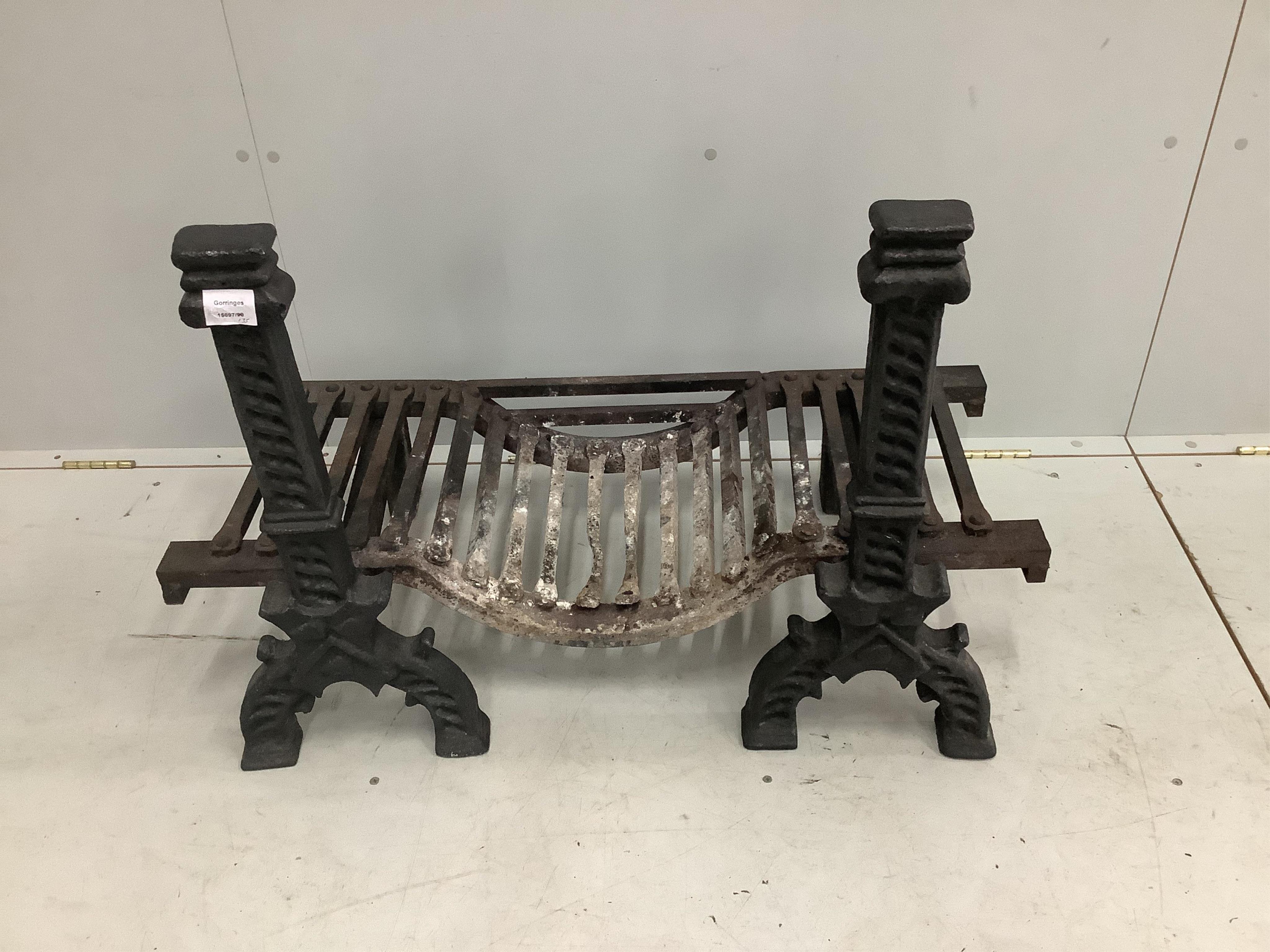 A pair of black painted cast iron fire dogs, a fire basket and a wrought iron fender. Condition - fair